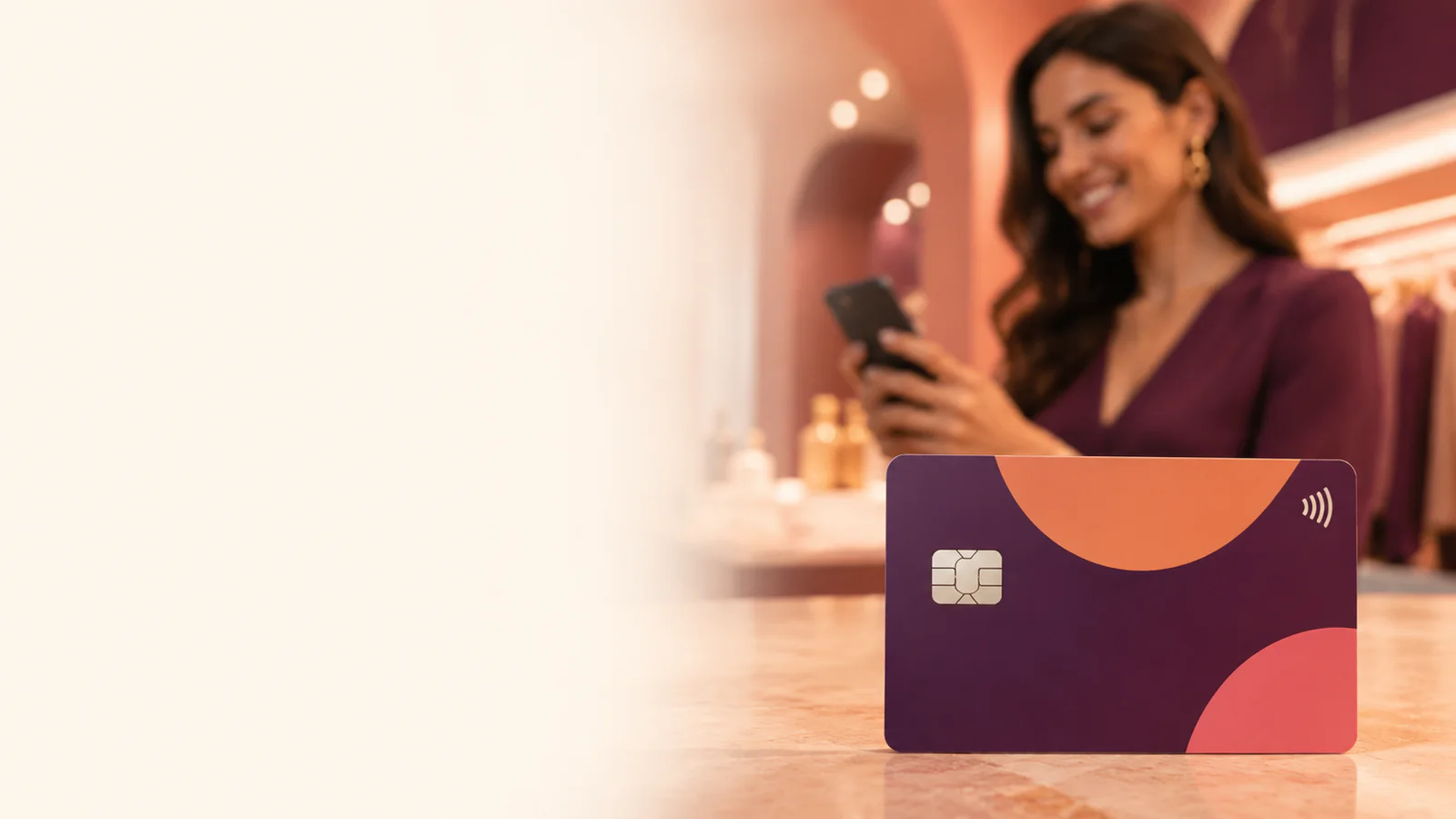 A clearly recognizable reward payment card with chip and contactless symbol in a warm customer setting